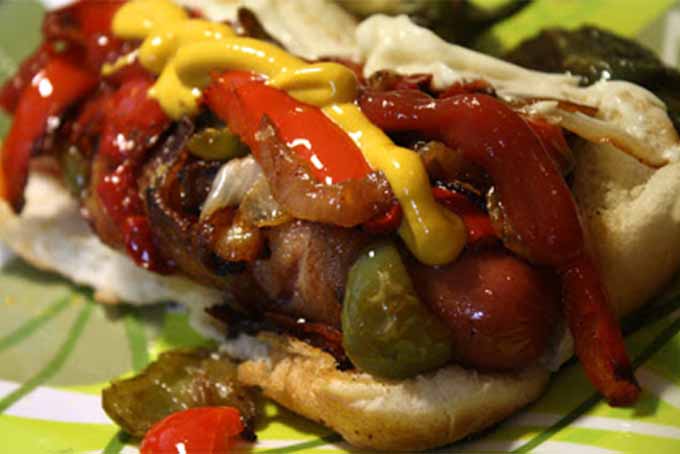 LA Street Dogs topped with peppers, onions, ketchup, and mustard.