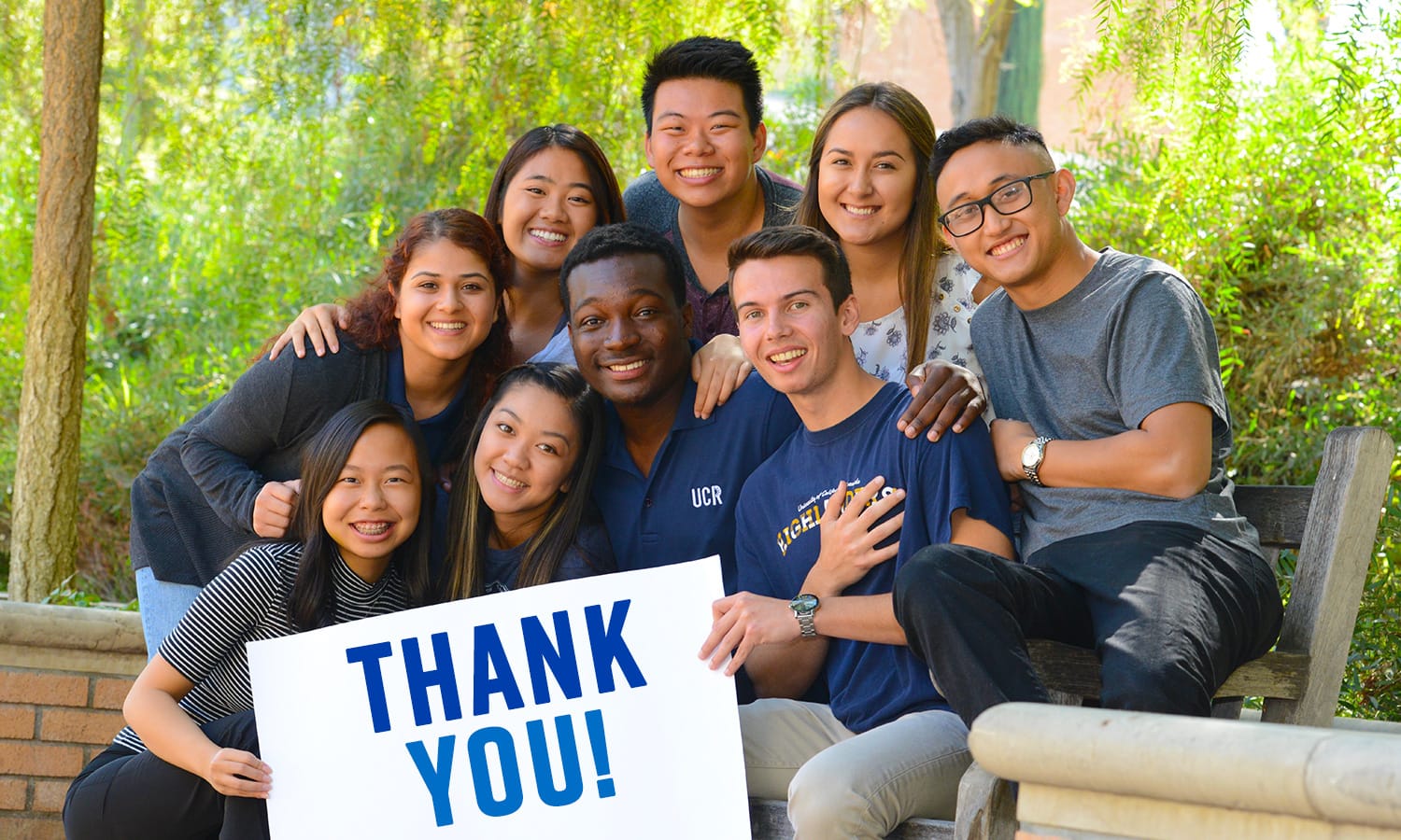 Diverse group of UC Riverside students with sign reading Thank You!