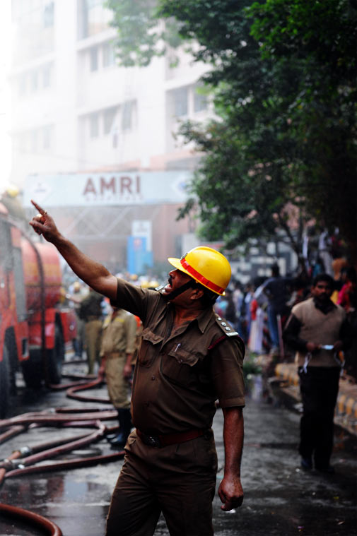 An Indian fireman shouts orders as rescue workers evacuate people from Amri Hospital after a fire engulfed the private hospital in the eastern Indian city of Kolkata. ? AFP Photo