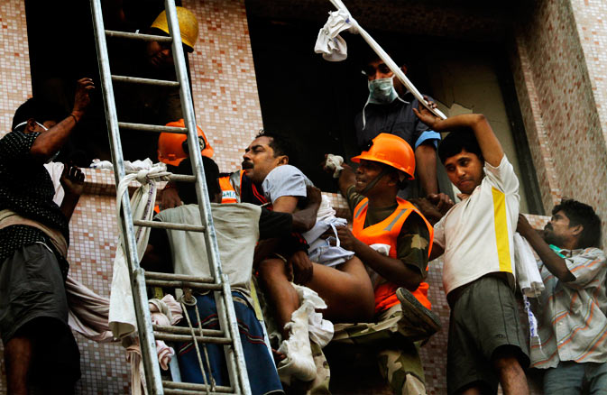 Fire officials rescue a patient from the window of a nursing home after it caught fire in Kolkata, India, Friday, Dec. 9, 2011. ? AP Photo