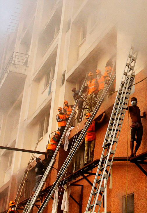 Fire officials try to enter a nursing home after it caught fire in Kolkata, India, Friday, Dec. 9, 2011. ? AP Photo