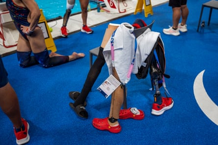 Athletes’ prosthetic legs lie against a chair