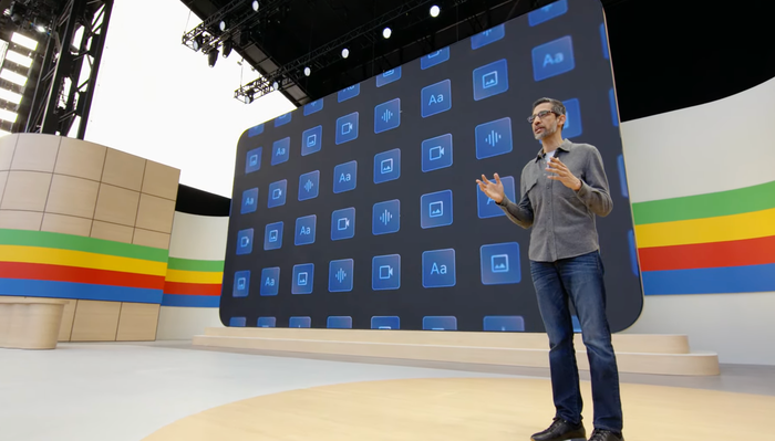 Sundar Pichai presenting onstage at a Google event.