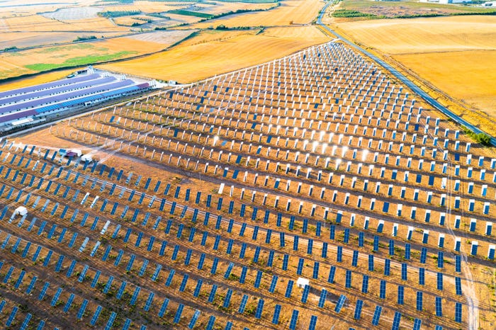 Aerial view of a solar farm in rural Spain surrounded by farm fields.