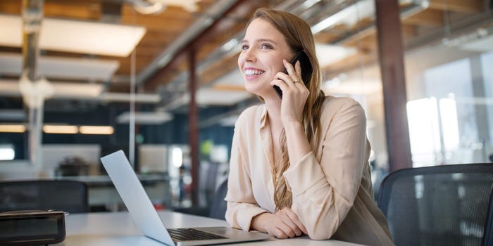 Young businesswoman in an office talking on cell phone about call options