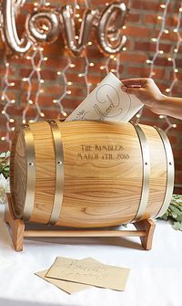 A unique wedding couple gift and keepsake, this miniature wood wine barrel personalized with the bride and groom's name, monogram or married name initial and wedding date is an attractive way to hold gift cards at the wedding reception. Guests drop their gift card in the slot. Later, the bride and groom can remove the knob-handled barrel end to remove the cards.