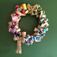 My Vintage spool wreath. I wired old spools to a fabric wrapped wire wreath form with floral wire. Next I wrapped the wreath with a vintage tape measure and finished it off by wiring on a tape measure bow.