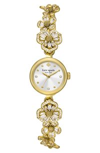 Round and baguette-cut crystals light up the strap of this stunning goldtone watch styled with a classic mother-of-pearl dial. 20mm case; 5mm band width Quartz movement Mother-of-pearl dial Mineral crystal face Stainless steel/crystal Imported