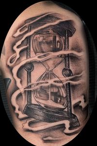 Black and grey hourglass with smokey background