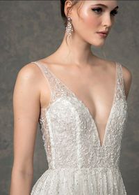 The meadow wedding dress is a deep V neck A-line gown with delicate bead work on bodice cascading onto skirt. #weddingdress #weddingdresses #romanticbride #alineweddinggown #bridalballgown #weddingown #bridalgown