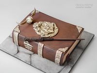 Harry Potter inspired cake designed by De la Creme Creative Studio - A Golden Snitch, Harry Potter's wand and a Hogwarts Crest all sculpted by hand!