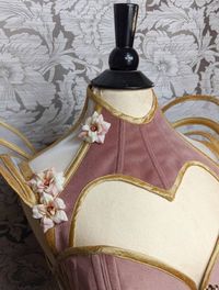 Visit our website www.valkyriecorsets.com to see more of our designs or follow us on Instagram to see our bespoke work. This beautiful elaborate corset and matching posture collar are made from dusky pink luxurious velvet, sheer corsetry mesh and stunning gold silk dupion. With detachable gold silk and mesh panniers and silk ruched suspenders. If you are interested in having this corset made in different colours send us an email to discuss your r