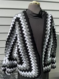 A beautiful Oversized Monochrome Cardigan is a perfect combination of Black Grey White for Unisex Clothing. The style is reminiscent of what Wednesday would wear due to the absence of bright colors make this piece perfect for Goth & Alt Wear. A beautiful sweater to wear every day and is 100% handmade by me and even has ribbed cuffs! This is made with acrylic yarn, wash and dry on gentle and low heat to keep this pristine as long as possible. Sweater took about 10-12 hours to complete, crocheting