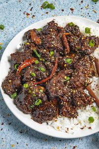 This Mongolian beef recipe is so easy to make with beef stir fried until crispy, then tossed in a sticky, spicy brown sauce, served with rice or noodles.