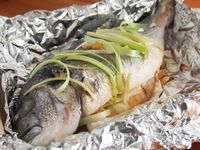 Steamed whole fish is a classic Chinese way to prepare it. But don't worry about not having a large steamer, you can make this delicious Chinese oven steamed fish with plain old foil. The result is wonderfully tender fish perfect any time. #wholefish #ovensteamedfish #Chinesefish