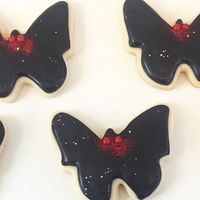 Cole Imperi 💀 Thanatologist on Instagram: "Sugar cookies! It has been like, 6 weeks? Since I last made some. I HAVE SO MUCH FUN MAKING THESE! I made Mothman and West Virginia cookies for a party we are hosting in WV. I love how my Mothmen came out! I also made whales for my friend. 🐳 This is also the first time I used disco dust! I’ll put more details in stories but disco dust, dust pumps and food coloring is from @grunderfullydelicious #royalicingcookies #mothmancookies #mothmanmuseum #mothma