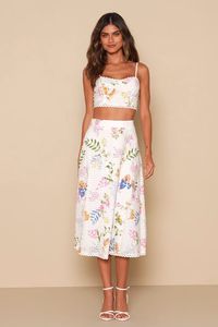 The Lulus Sweet At Heart White Floral Embroidered Two-Piece Midi Dress is tugging on our heartstrings! Lightweight woven fabric features a bright floral pattern and decorative eyelet embroidery throughout, shaping this sweet two-piece set. Adjustable spaghetti straps support a bustier-inspired bodice with scalloped lace trim at the neckline and hem, and a smocked panel at the back for fit. A high banded waist tops an A-line skirt that ends at a midi hem with matching scalloped lace trim. Hidden side zippers. Fit: This garment fits true to size. Length: Mid-calf length. Size medium Bust: Works best for A to C cup sizes - consider sizing up for fuller bust. Waist: Fitted - very fitted at natural waist. Hip: Not Fitted - fuller skirt allows room for hips. Undergarments: May be worn with a str