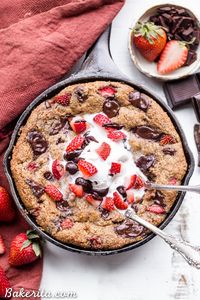 This Strawberry Chocolate Chunk Skillet Cookie is gooey in the middle, with crispy edges and all the flavors you love in a chocolate covered strawberry! This gluten-free, paleo and vegan skillet cookie will satisfy all your cravings - the fresh strawberries are the perfect fruity addition to this rich, chocolatey treat!