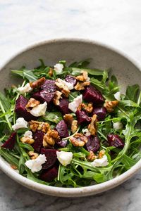 Easy, healthy, Arugula Salad with Beets, Goat Cheese, and Walnuts. With a simple lemon vinaigrette. Perfect combo!