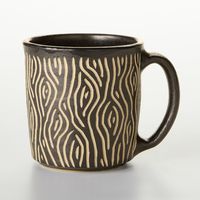 Ceramic Mug - Playfully carved with bold patterns using the sgraffito technique, these hand-built ceramic mugs add a dash of artistry to your morning routine. Dishwasher and microwave safe. Sold individually. Each holds 12 oz.