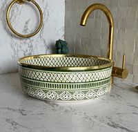 Add some Moroccan flair to your bathroom today and experience the beauty of this stunning vessel sink! This antique bathroom sink was handcrafted by artisans using traditional Moroccan methods making each sink unique by itself, therefore minor imperfections are to be expected. The production process of this wash basin goes through multiple fully organic steps. First, Through skilled artisan hands, ceramic is molded using a potter's wheel, then left to dry for a few days before getting fired usin