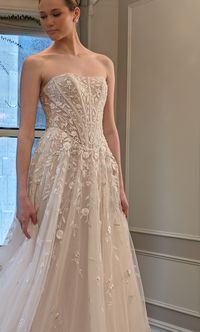 This stunning strapless A-line wedding dress is complete with hand embroidery and hand beaded details with a dropped basque waistline. Try on this Enaura Bridal wedding gown at Laura & Leigh!