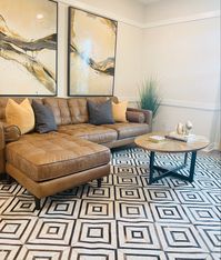 Loft design updated by with a mix of geometric rug design, leather sofa and art work. #rugdesign #geometric #remodelingahome