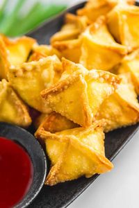 Ulta crispy cream cheese rangoons that are better than what you'd get at a restaurant! Filled with soft and flavorful cream cheese, they're so easy to make at home!