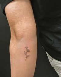 Minimalistic flowers tattoo located on the inner