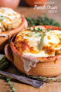 Slow Cooker French Onion Soup is one of our favorite meals to come home to! A rich beefy broth loaded with caramelized onions and herbs and topped with an amazing Gruyere cheese topping!