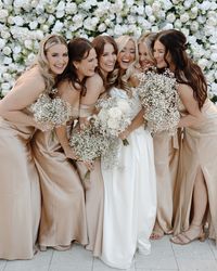 bridesmaids dress, champagne bridesmaids dress inspo, babies breath bouquets, candid wedding photography, bridesmaids pose inspo, white flower wall, white roses, wedding diy, joyful wedding day, wedding photographer