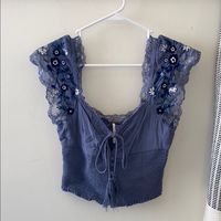 Never Worn, But No Tags. Free People, Blue Peasant Crop Top With Lace And Embroidery Detail With Navy Blue And White Flowers, Keyhole Detail With Bow In Front.