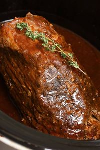 An eye of round roast in a crock pot after being fully cooked