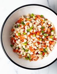 Bahamian Conch Salad Recipe - Enjoy a taste of the Bahamas at home with this refreshing raw seafood salad recipe. It's made with fresh conch (or shrimp!), fresh veggies like diced tomatoes and bell peppers, habanero pepper for a kick of heat, plus orange and lime juice to add a punch of bright citrus flavor. | A Spicy Perspective