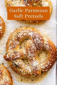 Homemade Garlic Parmesan Soft Pretzels are crispy and buttery on the outside and soft on the inside. Topped with garlic, parmesan cheese, and herbs for a perfect easy game day food or savory snack recipe! #softpretzels #garlicparmesansoftpretzels