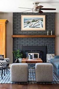 an elegant modern living room with a grey brick fireplace, a staine dmantel, lots of print for more interest and chic