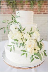 Wedding cake with white and green flowers at a Meridian Aviation Wedding in Meridian Mississippi by Margie's Mixing Bowl