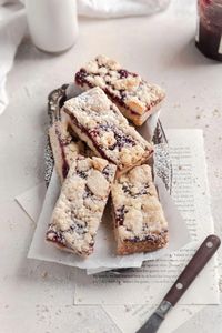 These easy jam bars are complete with a tender shortbread crust and jammy strawberry center! #easy #recipe #strawberry #raspberry #shortbread