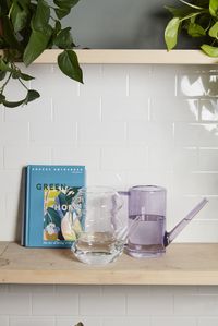 With a playful design that's simple & chic, this mouth-blown, high borosilicate glass Aqua Watering Can features trend-forward geometric stacked shapes, a tapered spout & an elegant, curved handle. Water plants easily with the small, lightweight style, or use as a vase & fill with a small bunch of florals or propagation clippings to warm up your interior design.