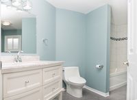 Freshly painted sea blue walls complemented this basement bathroom's stone-coloured tile flooring beautifully. #parliamentpainting #homedesign #burlont #oakvilleont