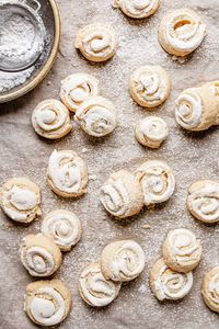 Soft buttery dough filled with sweet smooth meringue then rolled and sliced into beautiful rose-shaped cookies. |#cookies #buttercookies #meringuecookies #buttermeringuecookies #cookiesrecipe #meringuerecipe #easycookierecipe #cookiesidea #cookiephotography |