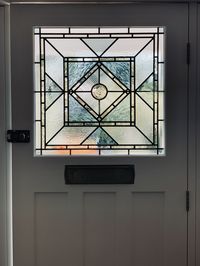 Minimal stained glass front door panel using handmade and textured glass.