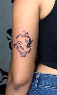 yin yang koi fish tricep tattoo