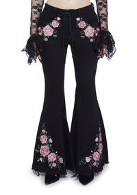 to dance under the stars. This twill flare pant has a lace-up front closure, front and back pockets, embroidered roses on the hips and legs, and a distressed hem.