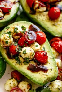 Basil Pesto Caprese Stuffed Avocado drizzled with balsamic glaze make an incredible light lunch or snack! Take creamy avocados to a different level! Sweet and juicy grape/cherry tomatoes with fresh mozzarella balls are tossed through basil pesto and spooned into avocado halves! | cafedelites.com