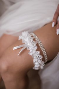 Handmade bridal garters set of two: 1. Bridal garter of crystal beaded embroidery and pearls (ca. 1 cm width) 2. Wedding garter made of delicate Italian lace with a satin bow (ca. 4 cm width) One can buy them separately. Please, check the right choice. Elevate your bridal ensemble with our enchanting crystal bridal garter set, a personalized touch to your wedding attire that exudes elegance and charm. 📏 Size Options: Refer to our size chart below to ensure the perfect fit: Medium (M): Circumfer