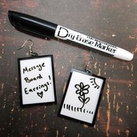 Show the world your thoughts with these Dry Erase Message Board Dangle Earrings! These earrings come with one black dry erase marker to start your messages! Writing wipes off with a dry cloth or paper towel! ★ These Big White Board Style Message Board Earrings are made of thin and light laser cut white and black acrylic! SO lightweight but Big so your message can get across! ★ This pair of Message Board Earrings measures 2″ tall, 1.5″ wide and are made with your chosen earring hooks! Pick from: