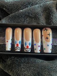 Handmade press-on nails  Made with gel polish and gems Placement of clown faces/look of french tip may differ slightly depending on length and shape 5 for showing design, full set of 10 nails per order Each set comes with application/care bag including file, buffer, wooden orange stick, alcohol pads, glue, and adhesive tabs!  Example photos in coffin, cut between long and extra long