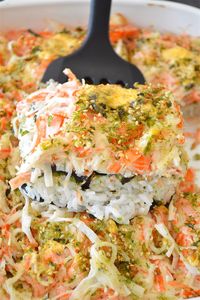 This is a Sushi Bake! It's basically the best parts of a giant California roll made 100x larger and requires no special sushi chef skills! This "casserole" is filled with a mouth-watering mayo/crab meat mixture, rice, nori, and topped with a yummy and simple spicy mayo sauce!