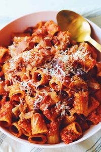 Rigatoni all Amatriciana is one of those perfect Italian dishes that’s on every menu in Rome. This spicy red sauce is laced with crispy bacon, tender onions and fiery red pepper flakes. Although it’s traditionally made with bucatini pasta and guanciale or pancetta, I use rigatoni and bacon because it’s easier to find where I live.